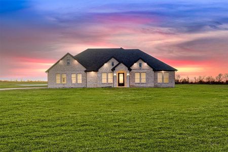 French country inspired facade featuring a lawn