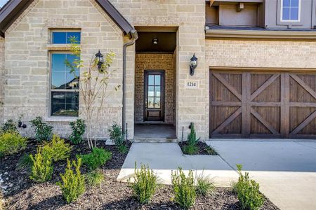 View of exterior entry featuring a garage