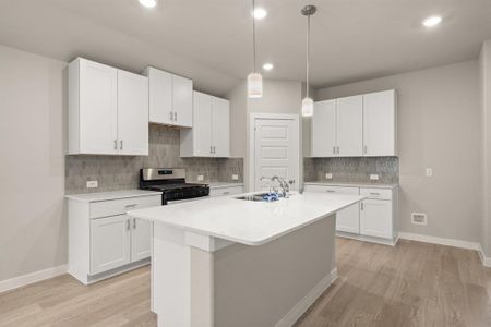 Welcome to the Gourmet Kitchen! The white cabinetry, oversized island, breakfast bar for additional seating and Stainless Steel appliances are just a few of the highlights.