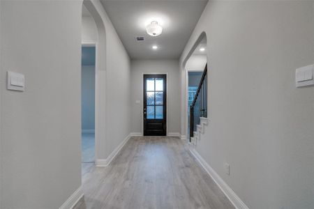 Entrance foyer with light wood-type flooring