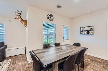 Dining room with visible vents, baseboards, and wood finished floors Dining room with visible vents, baseboards, and wood finished floors