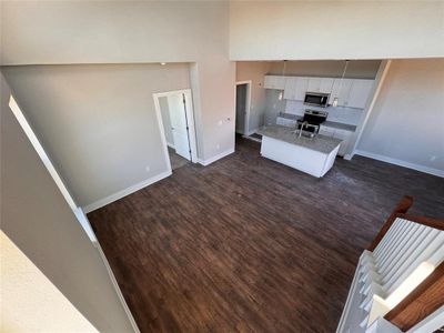 Kitchen with appliances with stainless steel finishes, dark hardwood / wood-style floors, sink, and white cabinets