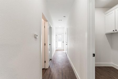 Hallway with dark hardwood / wood-style floors