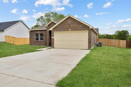 View of front of property featuring a front lawn, a garage, and central AC