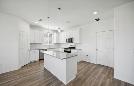 Bright kitchen with oversized island *real home pictured