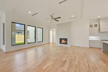 Relax and entertain in the large family room open to the kitchen. The gas log fireplace is a focal point and is wired and set for a television above it. Large windows overlook the courtyard with Lanai and summer kitchen.