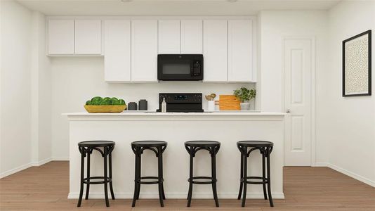 Kitchen with a kitchen breakfast bar, stove, light wood-type flooring, and white cabinetry