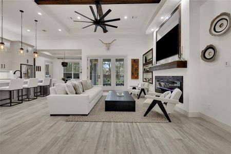 Luxurious family room open to the kitchen! Wooden accent beams on ceiling. Electric fireplace is on in one press of the button with or without heat!