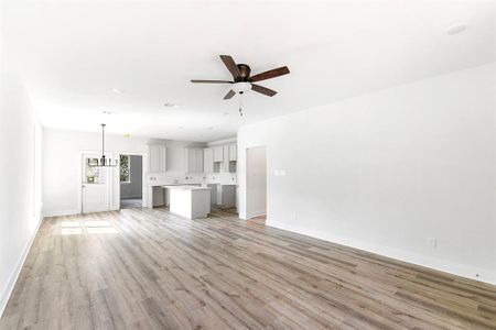 Vinyl wood plank floors in family room and kitchen.  High ceilings and plenty of room for your larger furniture.