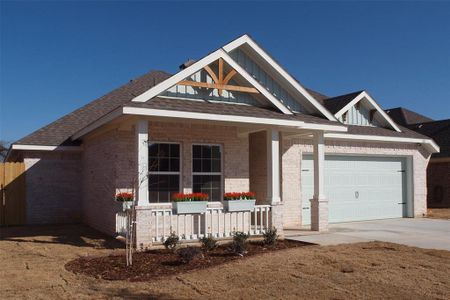 View of front of property featuring a porch and a garage