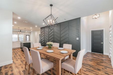 Dining area with a notable chandelier and light hardwood / wood-style floors