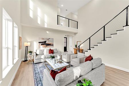 Living room featuring light hardwood / wood-style floors and a high ceiling