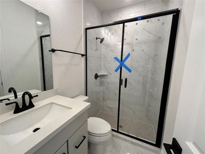 The downstairs secondary bathroom includes a stand-up shower, making it ideal for accommodating guests with ease