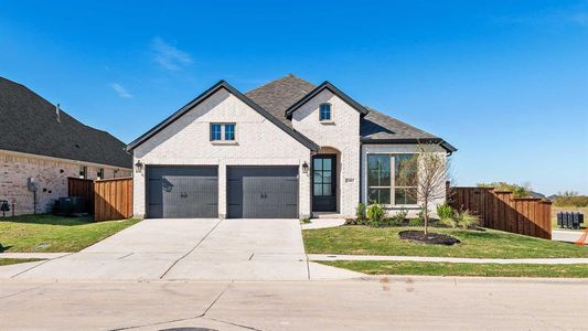 View of front of home featuring central AC unit, a front yard, and a garage