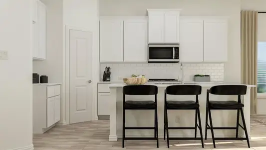 Kitchen with a kitchen breakfast bar and white cabinetry