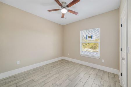 Spare room with light hardwood / wood-style floors and ceiling fan