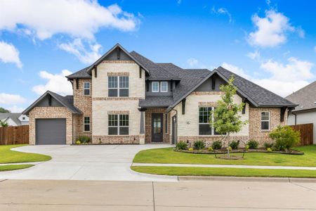 View of front of house with a garage and a front yard