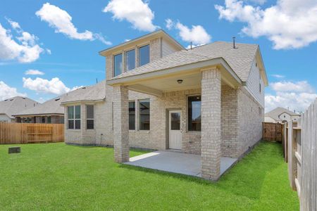 The covered patio is generously sized, providing ample space for various outdoor activities.