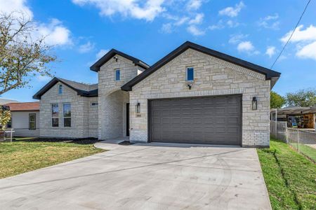 View of front of home featuring a garage and a front yard