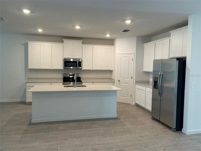 Kitchen with SS appliances, quartz countertops.