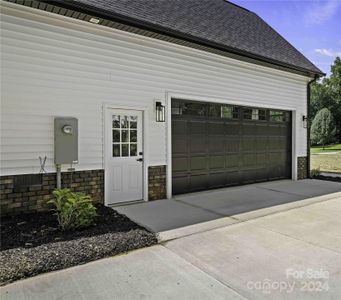 Lots of parking with Two Car Garage & long driveway. Notice the door in the Garage.