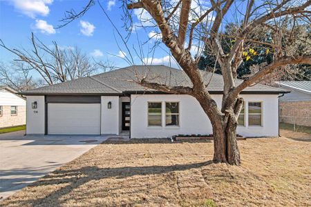 View of front of house with a front lawn and a garage