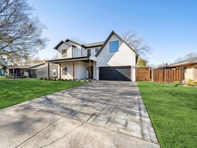 View of front of home featuring a front lawn and a garage