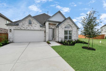 Meticulously maintained yard and lush landscape, paired with a premium elevation featuring captivating brick accents. Modern coach lights add a touch of contemporary elegance to the exterior.