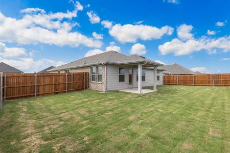 Rear view of house with a patio area and a yard