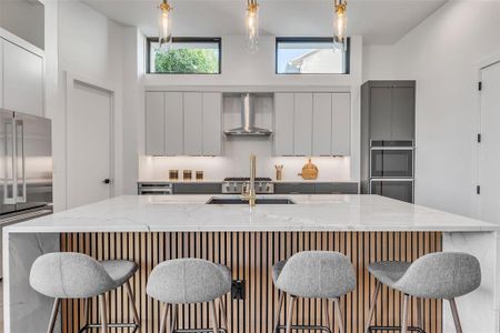 Elevate your culinary experience in this stunning kitchen, complete with marble countertops, custom cabinetry, and luxe gold fixtures.