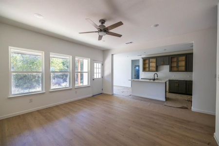 Unfurnished living room with light hardwood / wood-style floors and ceiling fan