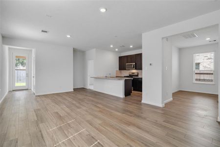 Another view from the family room into the kitchen, dining and den areas.