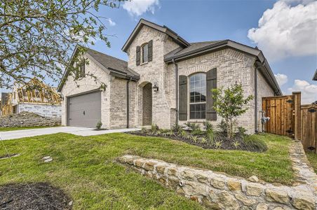 French country home with a front yard and a garage