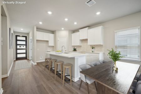 Virtually staged dining room and kitchen in the Matador floorplan in the Meritage Homes community.