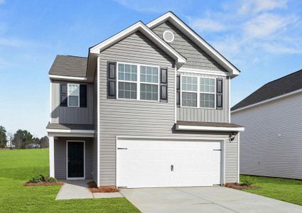 Burke house front with green grass, light brown paneling, and white two-car garage door