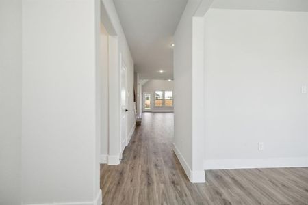 Hallway with light hardwood / wood-style floors