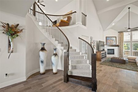 Curved staircase greets you and leads you to the living room