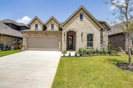 View of front of home featuring a garage and a front yard