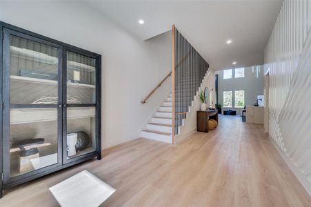 Foyer with a towering ceiling and light hardwood / wood-style flooring