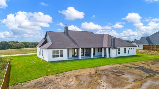 Rear view of property featuring a yard