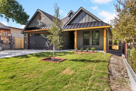 View of front of house with a front yard and a garage