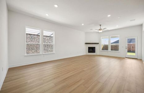 Bright gathering room with elegant fireplace *real home pictured