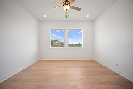 Unfurnished room featuring light wood-type flooring and ceiling fan