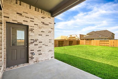 Experience outdoor living at its finest on this expansive covered patio, thoughtfully designed for BBQs and delightful outdoor dining. Sample photo of completed home with similar floor plan. As-built interior colors and selections may vary.