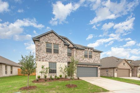 View of front of property featuring a garage and a front lawn