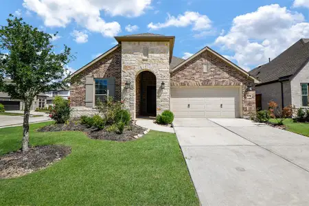 This charming home features a modern brick and stone exterior with a two-car garage. It includes a well-maintained front yard with landscaped garden beds, offering great curb appeal in a pleasant neighborhood setting. This charming home features a modern brick and stone exterior with a two-car garage. It includes a well-maintained front yard with landscaped garden beds, offering great curb appeal in a pleasant neighborhood setting.