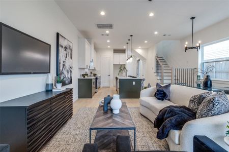 Living room featuring a chandelier and light hardwood / wood-style floors