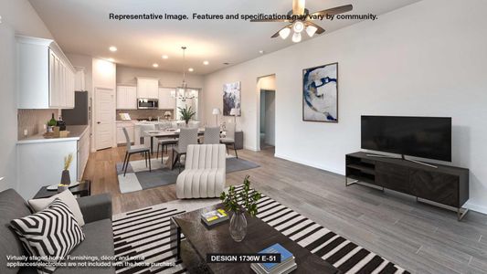 Living room with ceiling fan with notable chandelier and light hardwood / wood-style flooring