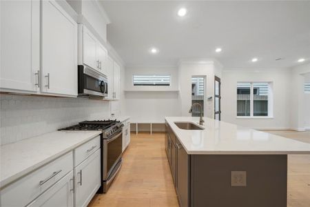 The kitchen is equipped with Stainless Steel LG Appliances (Microwave, Gas Range, Oven & Dishwasher). (Sample photos of a completed Chesapeake floor plan. The image may feature alternative selections and/or upgrades.)