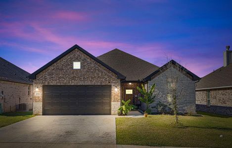 View of front of house featuring a yard, a garage, and cooling unit